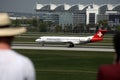 Helvetic Airways plane. Plane spotters watching airplanes