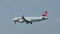 Helvetic Airways plane approaching the airport, blue sky