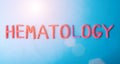 HEMATOLOGY inscription in red letters on a blue background. Leukemia blood disease concept, biomedicine