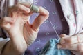 Hemming a dress, woman hands needlework