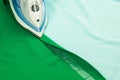 Hemming, shortening green courtain fabric with an adhesive iron-on hemming tape Royalty Free Stock Photo