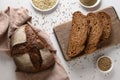 Loaf of freshly baked hemp bread and hempseeds on white background.