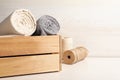 Hemp cloths in crate and threads on white wooden table, space for text Royalty Free Stock Photo