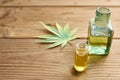 Hemp oil in a glass jar, hemp leaves on the background of wooden boards Royalty Free Stock Photo