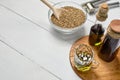 Hemp seed and garlic pressing masher on the table, oil in a glass jar and bottle on the background of wooden boards Royalty Free Stock Photo