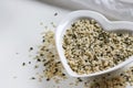 Hemp seeds in heart shaped ceramic bowl Royalty Free Stock Photo