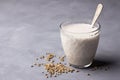 Hemp seeds in a wooden bowl and hemp milk on gray background Royalty Free Stock Photo