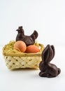a hen and a chocolate rabbit with eggs in a nest Royalty Free Stock Photo