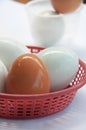 Hen egg and salted egg in plastic basket Royalty Free Stock Photo