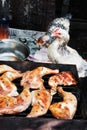 Hen staring at chicken meat on grill Royalty Free Stock Photo