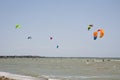 Henichesk, Ukraine - July 12, 2021: Kitesurfing. Practicing kitesurfing at summer beach. Kitesurfer doing tricks. People enjoy