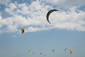 Henichesk, Ukraine - July 12, 2021: Kitesurfing. Practicing kitesurfing at summer beach. Kitesurfer doing tricks. People enjoy