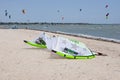 Henichesk, Ukraine - July 12, 2021: Kitesurfing. Practicing kitesurfing at summer beach. Kitesurfer doing tricks. People enjoy