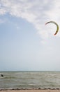 Henichesk, Ukraine - July 12, 2021: Kitesurfing. Practicing kitesurfing at summer beach. Kitesurfer doing tricks. People enjoy