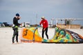 Henichesk, Ukraine - July 12, 2021: Surfer in wetsuit do trick. Kitesurfing athlete on kite board. Foiling kiteboarding