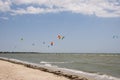Henichesk, Ukraine - July 12, 2021: Surfer in wetsuit do trick. Kitesurfing athlete on kite board. Foiling kiteboarding