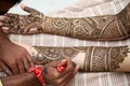 Henna being applied to bride's hand Royalty Free Stock Photo