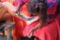 Henna body painting artist at work Royalty Free Stock Photo