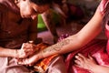 Henna Designs Being Painted on a Woman`s Arm