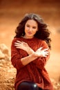 Henna Mehndi. Mehendi on hands. Outdoor portrait of attractive woman in sweater with curly hair