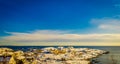 Henningsvaer, Norway - April 09, 2018: Beautiful above view of wooden buildings covered with snow over a rocky island in