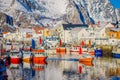 Henningsvaer, Norway - April 04, 2018: Outdoor view of fishing port in Henningsvaer with typical red wooden buildings