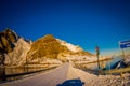 Henningsvaer, Norway - April 04, 2018: Outdoor view of frozen street covered with snow and traffic lights an informative Royalty Free Stock Photo