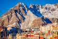 Henningsvaer, Norway - April 04, 2018: Picturesque fishing port in Henningsvaer with typical red wooden buildings and