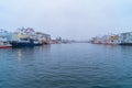 Henningsvaer village in Lofoten islands, Nordland county, Norway, Europe. Ships and boats in marina port in harbor in winter