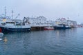Henningsvaer village in Lofoten islands, Nordland county, Norway, Europe. Ships and boats in marina port in harbor in winter