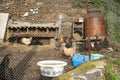 Hens inside a rustic chicken coop behind the fence eating next to a nesting box and basins for water Royalty Free Stock Photo