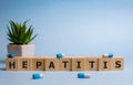 Hepatitis word from wooden blocks on blue background