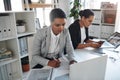 Her ambition pushes her to succeed even further. two attractive young businesswomen working together inside a modern Royalty Free Stock Photo