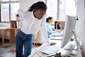Her back is starting to act up. a young businesswoman experiencing back pain while working at her desk in a modern Royalty Free Stock Photo