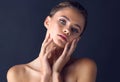 Her eyes calms the soul. Studio shot of an attractive young woman posing and touching her face gently with her hands.