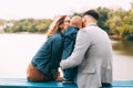 Her family sitting on the bench near a lake having some nice time together Royalty Free Stock Photo