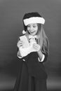 Her first cell phone. Happy girl got phone for Christmas. Getting mobile phone as gift. Phone from Christmas stocking Royalty Free Stock Photo