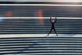 Her fitness game is a step ahead. High angle shot of an attractive young sportswoman doing jumping jacks on outside