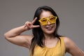 Hand gesture, stylish glasses show playful personality