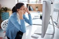 Her mind is rebelling against her. a young businesswoman looking stressed while using a laptop at her desk in a modern