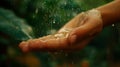 On her palm the droplets seem to be a source of life sustaining her with their delicate presence.