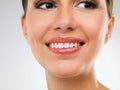 Her smile is as perfect as her skin. Closeup studio shot of a beautiful young woman smiling happily. Royalty Free Stock Photo