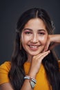 Her smile is beautiful. Cropped portrait of an attractive teenage girl standing alone against a dark studio background Royalty Free Stock Photo