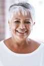 Her smile is still as great as ever. Portrait of a cheerful mature woman with a bright smile looking at the camera.