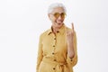 Her sould is young. Portrait of joyful pleased and carefree enthusiastic grandmother with grey hair in stylish Royalty Free Stock Photo