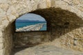 HERACLION, GREECE - November 2017: View of the pier through the embrasure of old Venetian fortress Koule, Crete, Royalty Free Stock Photo