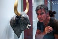 Man looking at bull`s head