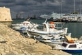 HERAKLION, GREECE - November, 2017: colorful fishing boats near old Venetian fortress Koule, Heraklion port, Crete Royalty Free Stock Photo