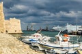 HERAKLION, GREECE - November, 2017: colorful fishing boats near old Venetian fortress Koule, Heraklion port, Crete Royalty Free Stock Photo