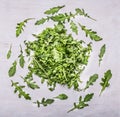 Herb arugula nested circles on a white wooden background top view Royalty Free Stock Photo